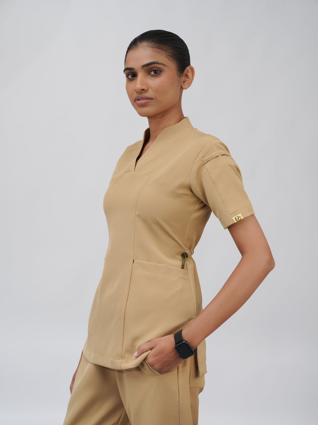 Sqwish premium scrub top for doctors - Sand Skin - three-quarter side view
